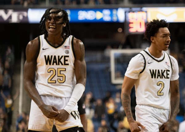 Tre’Von Spillers (25) and Juke Harris (2) celebrate together in their first season as Demon Deacons. The transfer forward and freshman guard combined for 27 points and 10 rebounds in Sunday's 72-70 win over Michigan.